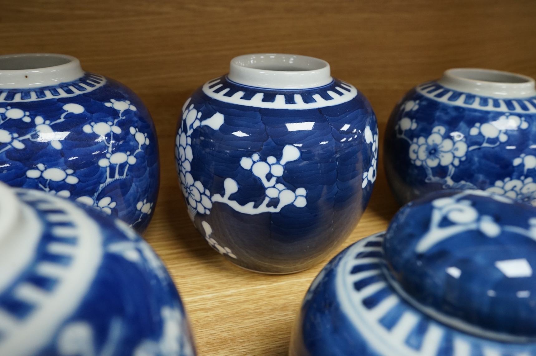 Eleven Chinese blue and white prunus jars, and two covers, late 19th/20th century, largest 16cm high